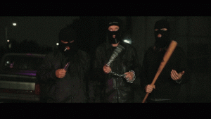 Group of masked men branding weapons