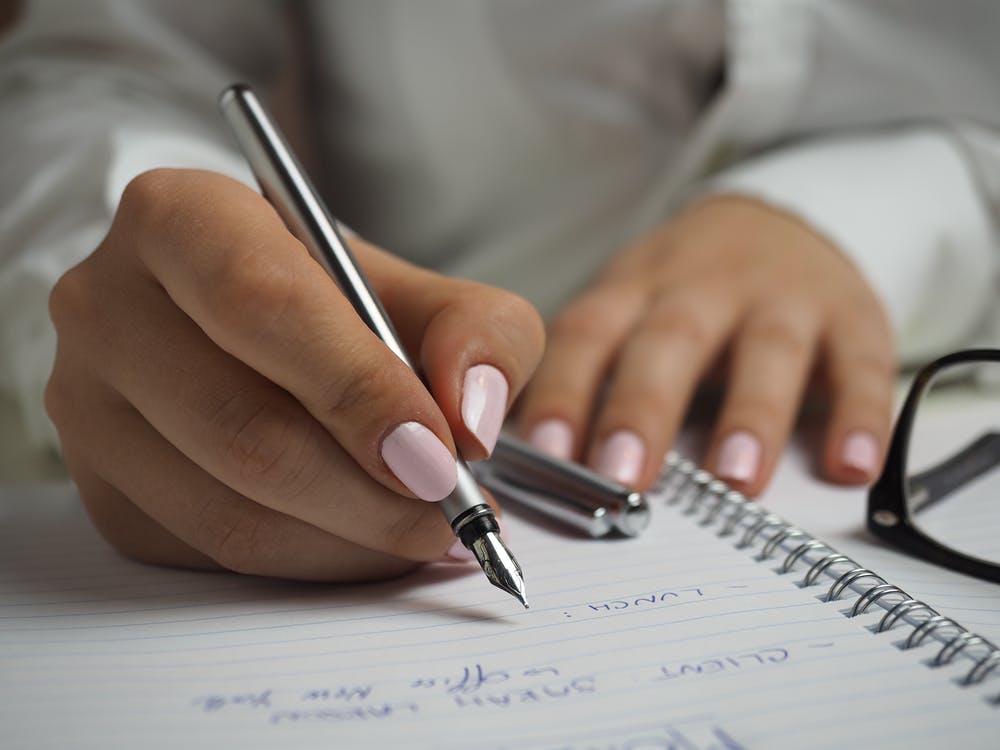 Women writing in a notebook