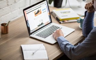 Man looking at a laptop on his desk