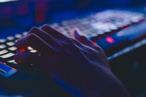 A hand typing at a keyboard