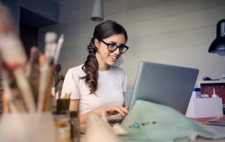 A woman writing on her laptop